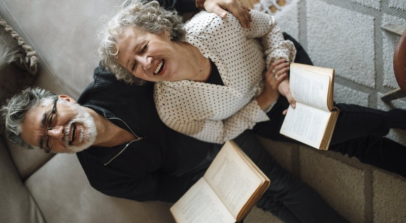 Senior couple reading together at home