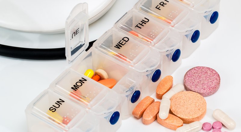 Weekly pill organizer with vitamins and supplements